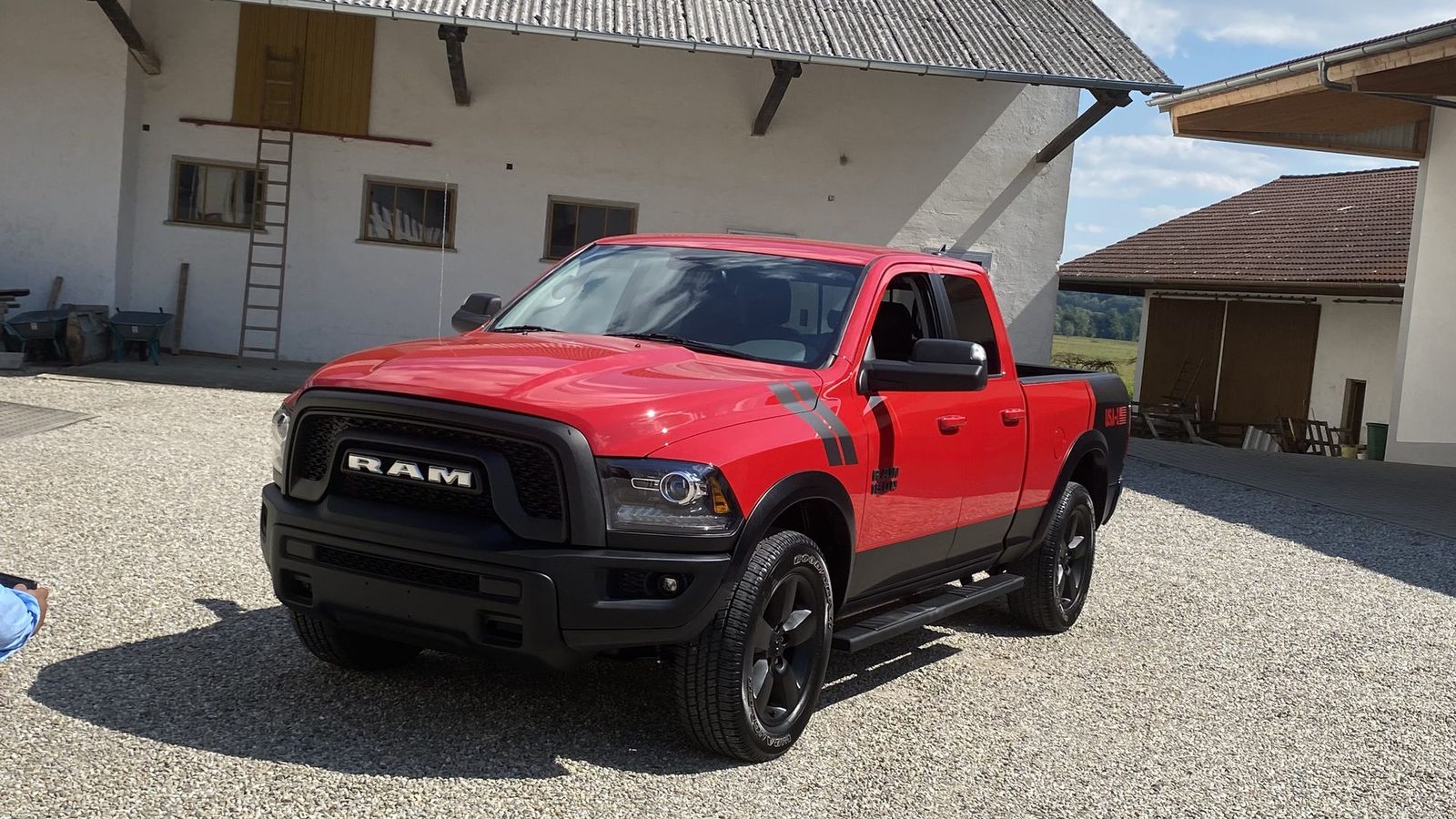 RAM 1500 Classic Warlock Quad Cab 4x4 in Flame Red — Frontansicht schräg mit schwarzem Kühlergrill