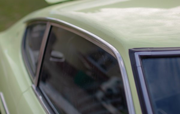 Lime Yellow 1972 Datsun 240Z side profile showing the full S30 shape from front wing to rear hatch