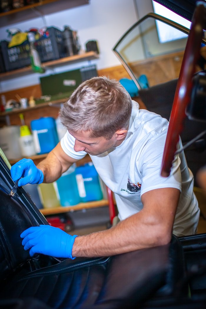 Bodywork of a Datsun 240Z inspected under a detailing light