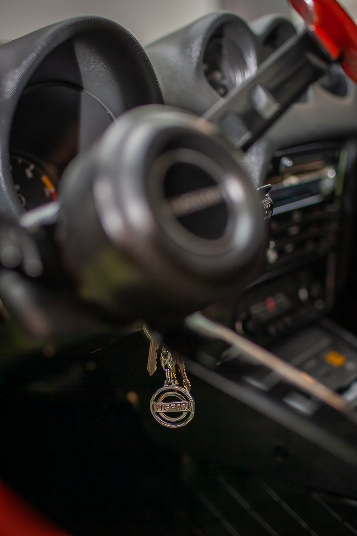 Chrome door handle set into the Lime Yellow bodywork of a Datsun 240Z
