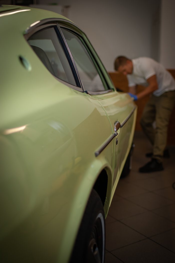 Final wipe down of the Lime Yellow paintwork on a Datsun 240Z
