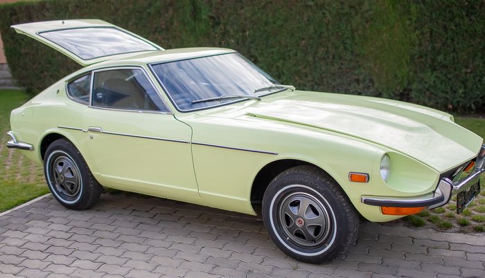 Lime Yellow Datsun 240Z seen from the side outdoors