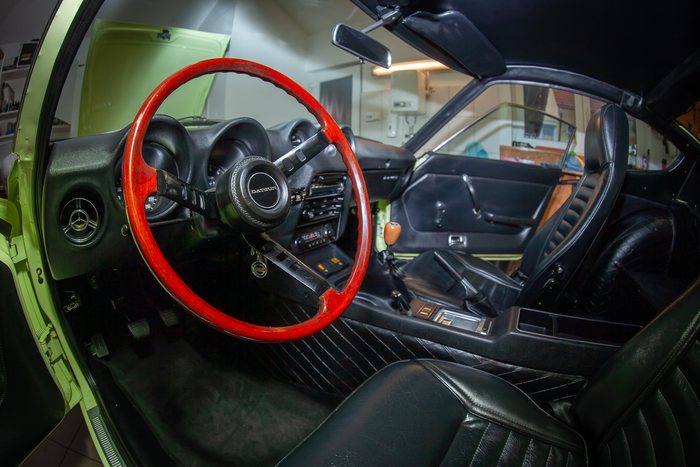 Wheel being cleaned during the detailing of a Datsun 240Z