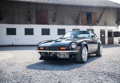 Low angle front view of a black Datsun 280Z widebody