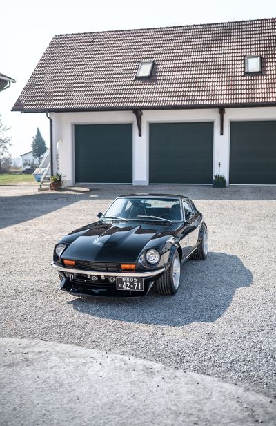 Black Datsun 280Z widebody front three-quarter from a low angle