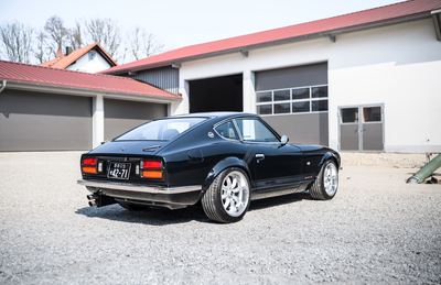 Black Datsun 280Z widebody rear three-quarter outdoors