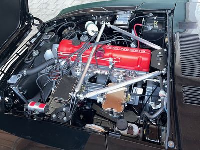 Overview of the rebuilt L28 engine bay with twin Mikuni carburettors in a Datsun 280Z