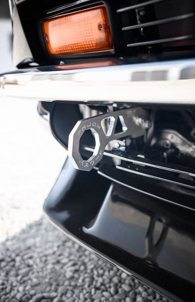 Machined tow hook mounted below the front bumper of a Datsun 280Z