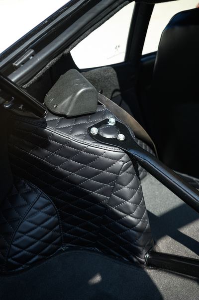 Quilted black trim and roll bar inside a Datsun 280Z