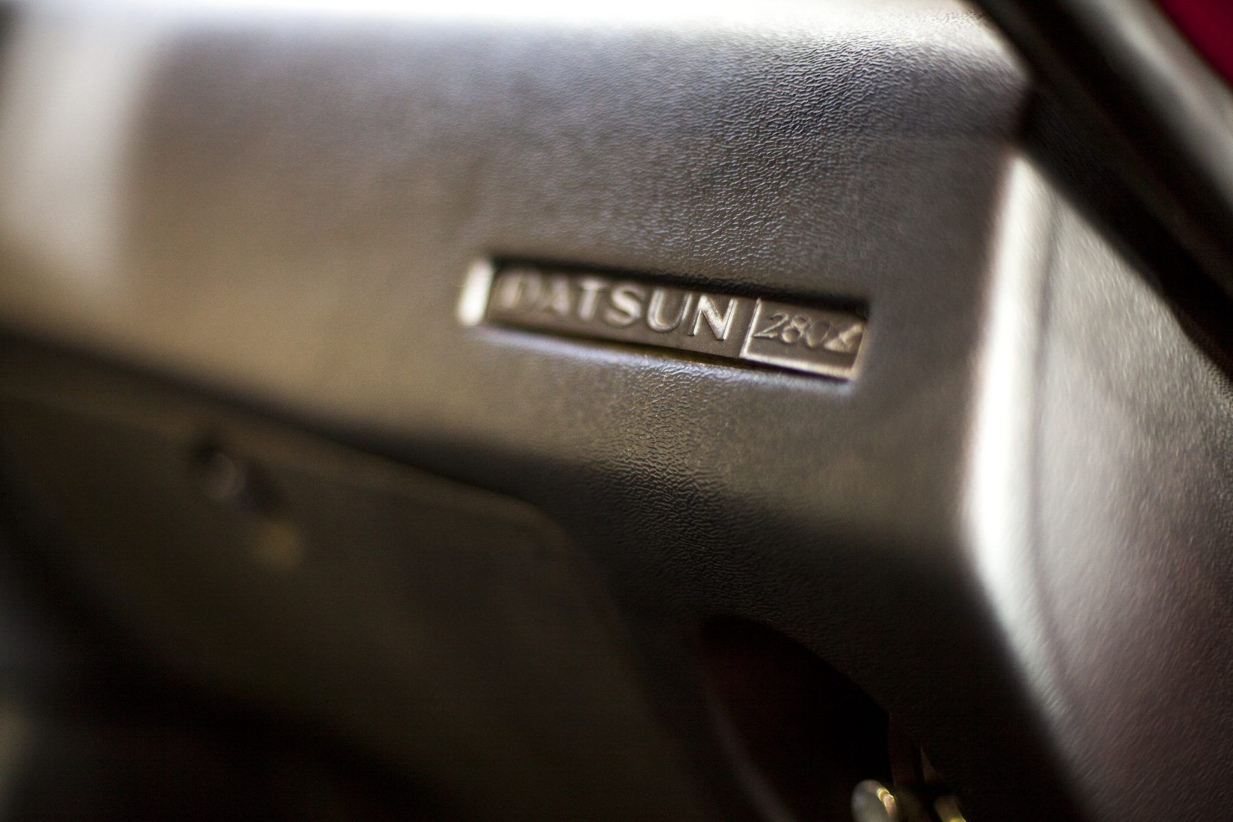 Original Datsun 280Z badge moulded into the dashboard of the 1976 car