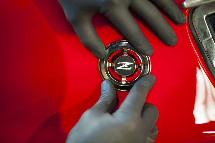 Z-embossed fuel filler cap on the red rear wing of a Datsun 280Z