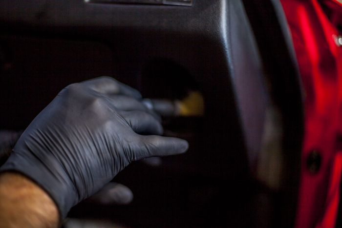 Interior trim panel being cleaned during final detailing of a Datsun 280Z