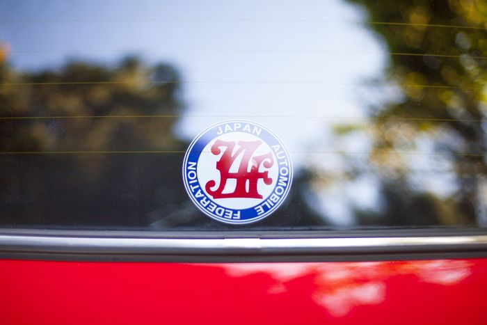 Japan Automobile Federation badge fixed in the rear glass of a Datsun 280Z