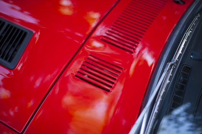 Cowl vent and bonnet shut line on a red Datsun 280Z