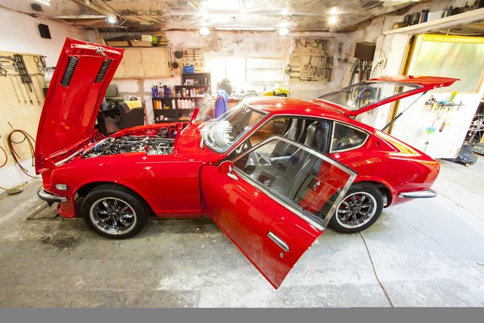 Red Datsun 280Z with both doors open, showing the cabin and sill