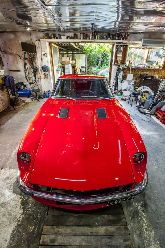Red Datsun 280Z photographed head-on, showing the low nose and headlight buckets