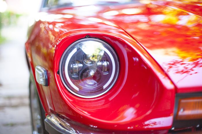 Headlight and surround of a red Datsun 280Z