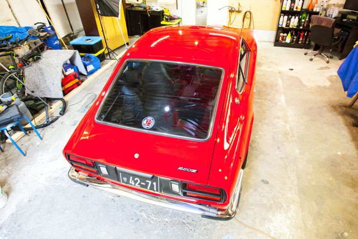 Red Datsun 280Z from a high rear three-quarter angle, showing roof and hatch glass