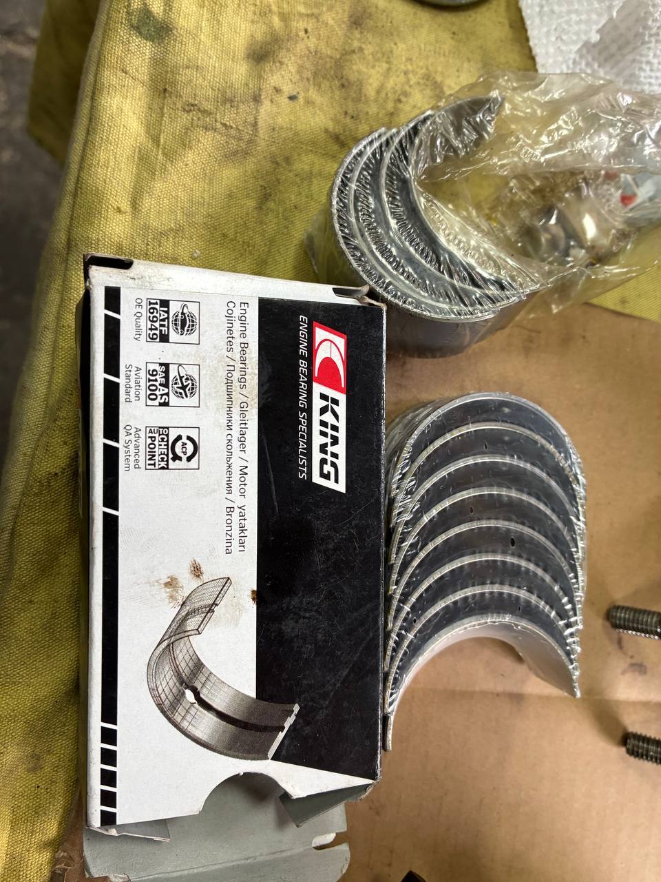 New main bearing seated Datsun L24 block cap — 240Z engine rebuild