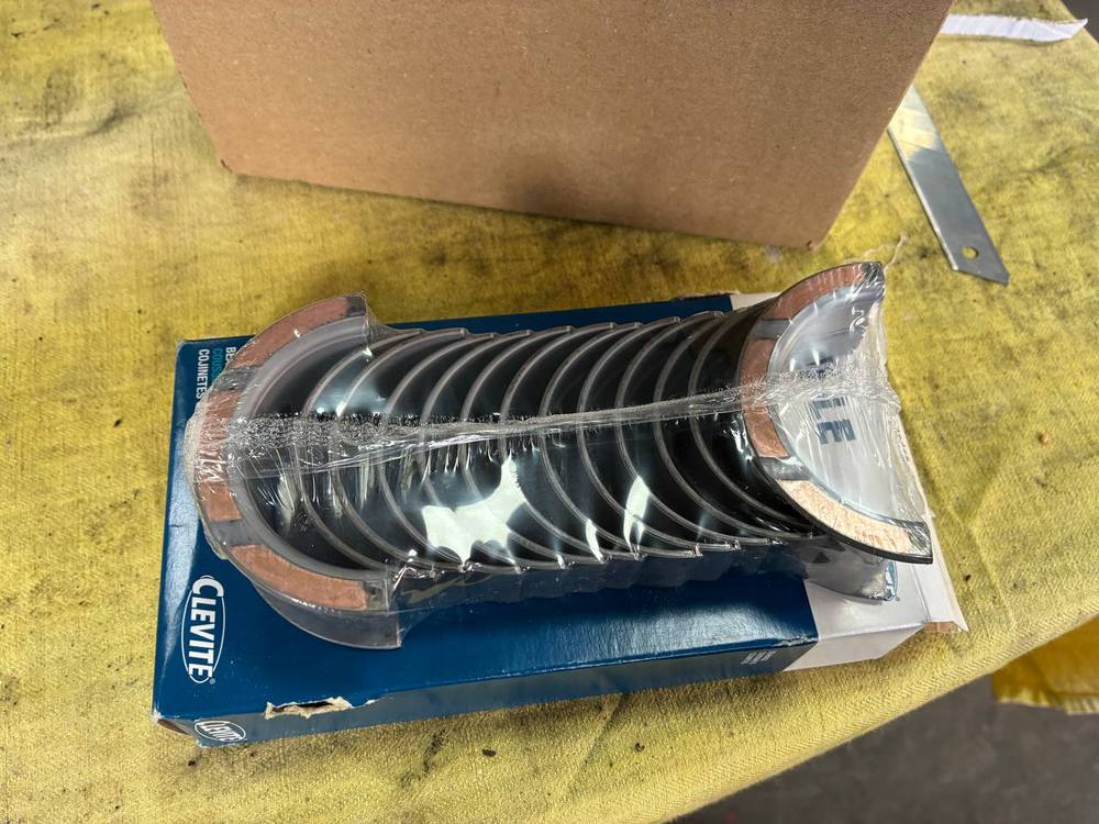 New front crank seal fitted refinished Datsun L24 timing cover — 240Z engine rebuild