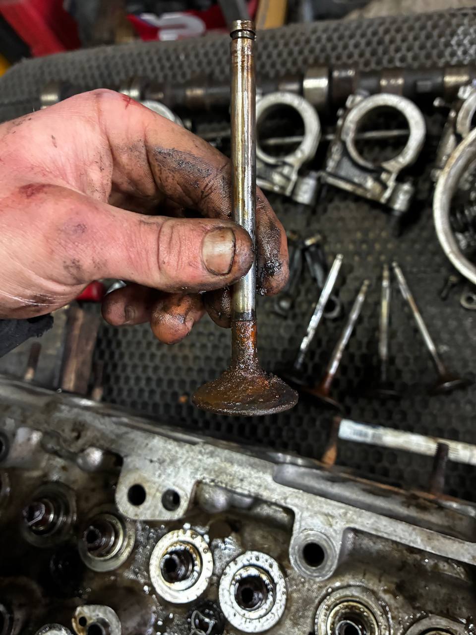 Worn Datsun 240Z L24 valve carbon buildup before replacement — engine rebuild