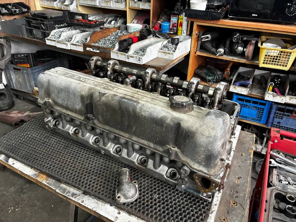 Datsun L24 cylinder head valvetrain camshaft laid out — engine teardown