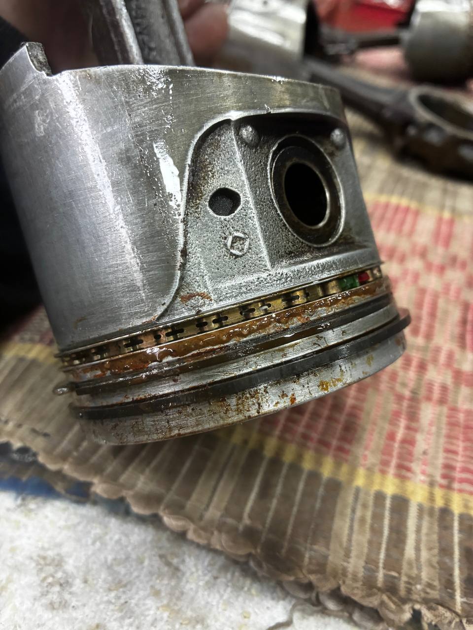 Datsun L24 connecting rod piston assembly removed — S30 engine teardown