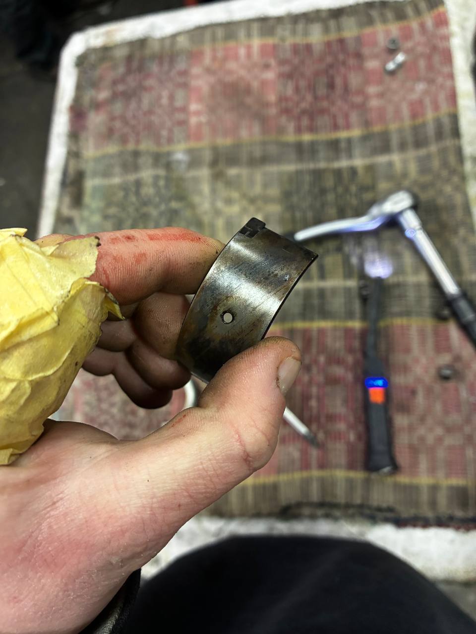 Worn Datsun L24 piston ring carbon varnish before replacement — engine rebuild