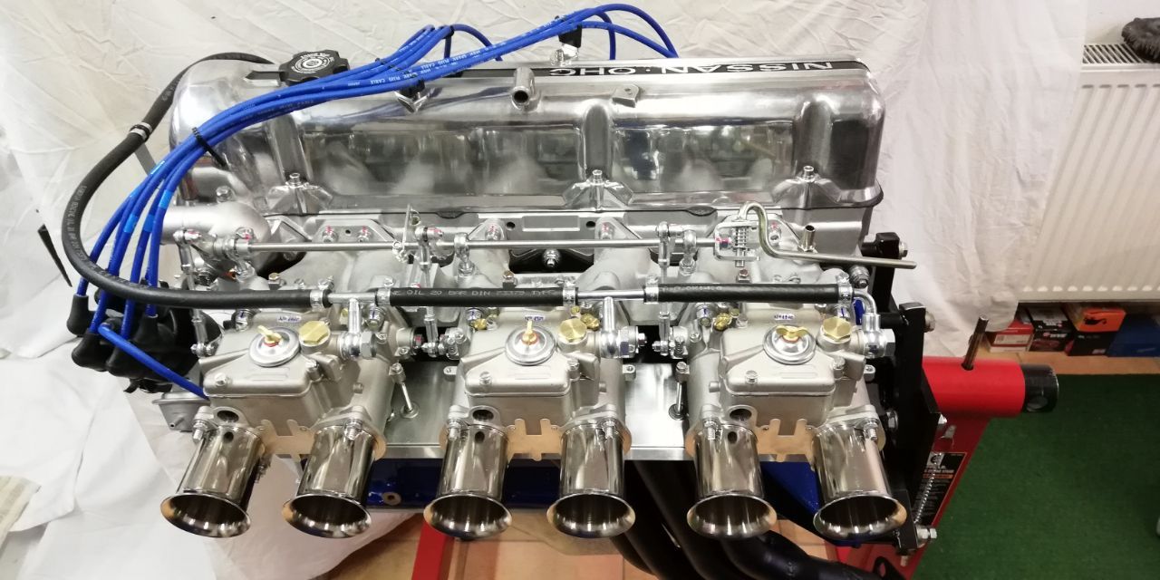 Rebuilt Datsun 280Z engine with triple Weber carburettors, polished NISSAN OHC valve cover and Datsun blue block