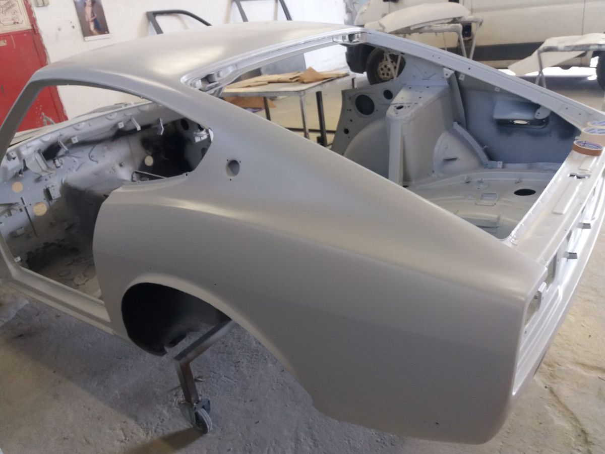 Datsun 280Z shell in primer during paint preparation — classic car restoration paintwork stages