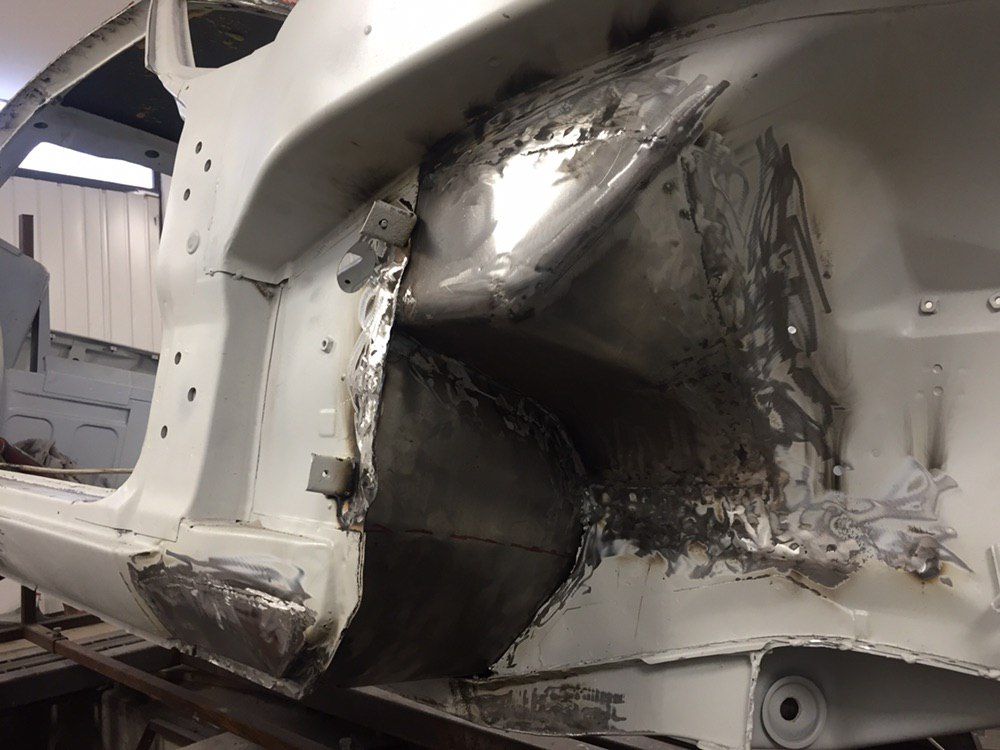 New metal welded into the wheel arch of a Datsun 280Z — rust repair on a classic Datsun Z