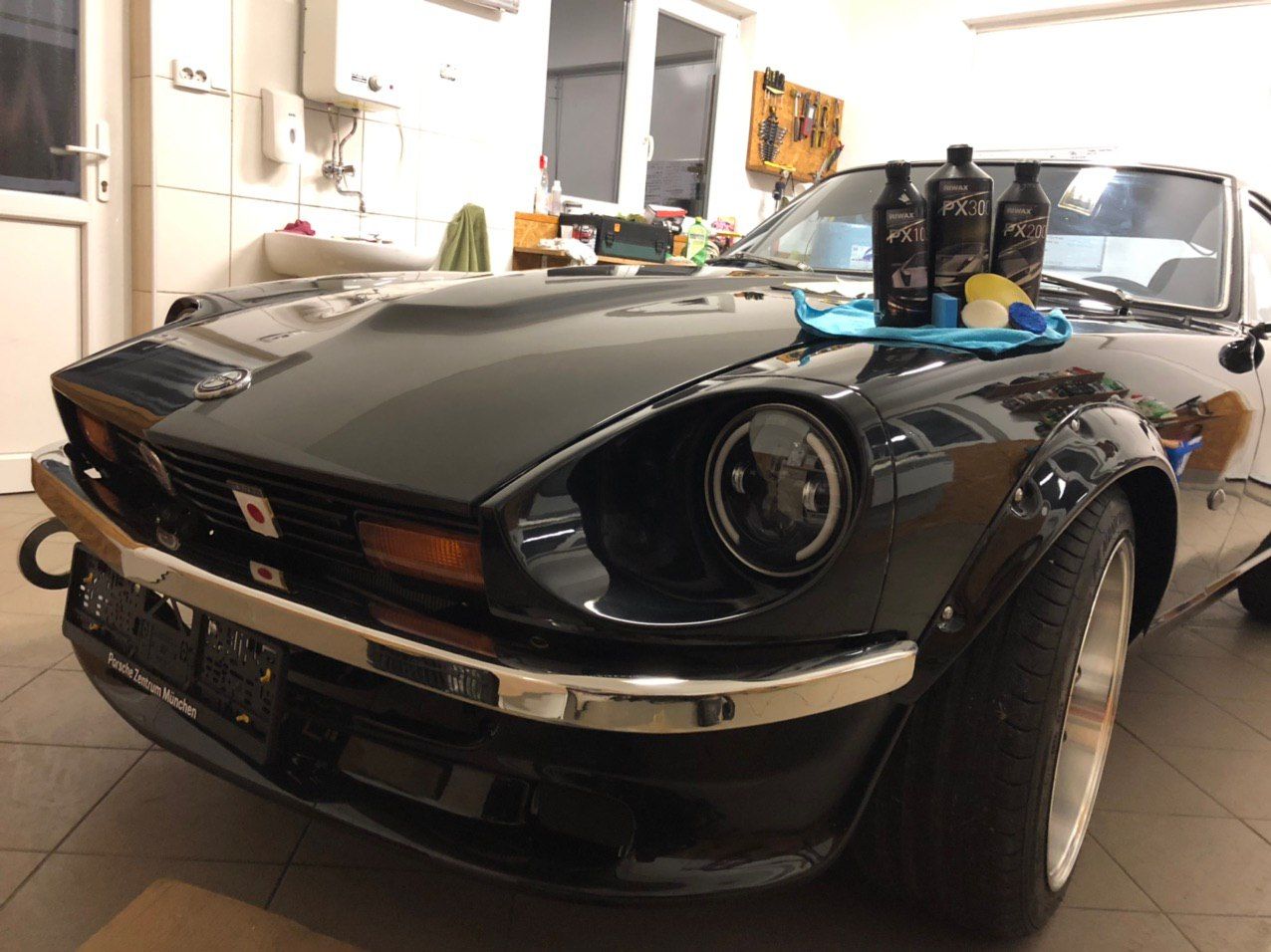 Finished restored black Datsun 280Z classic car after final detailing — ready for worldwide delivery