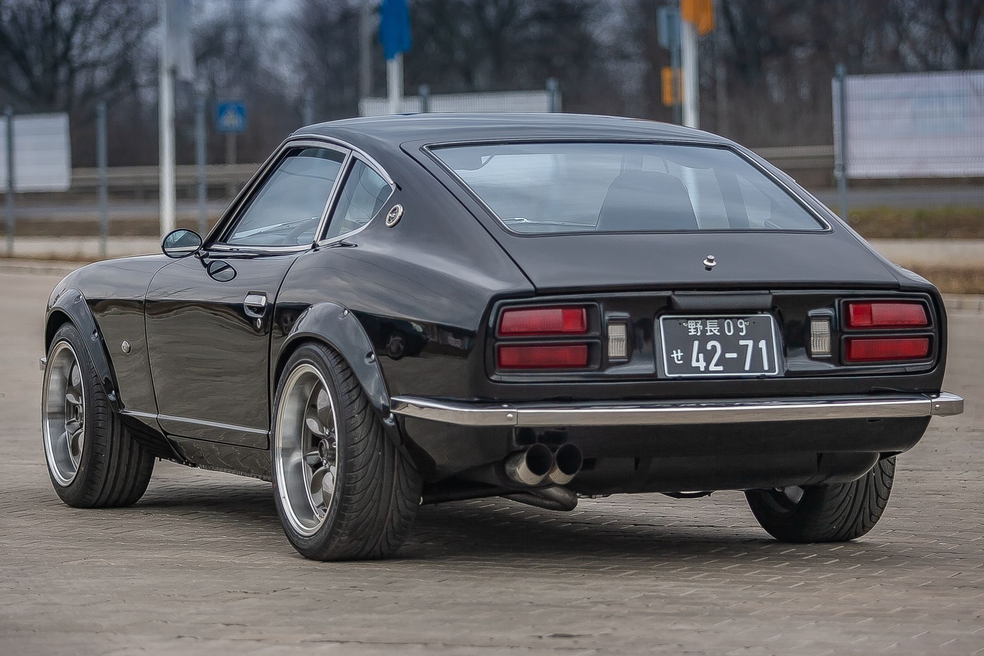 Fully restored black Datsun 280Z classic car — custom build, rear three-quarter view