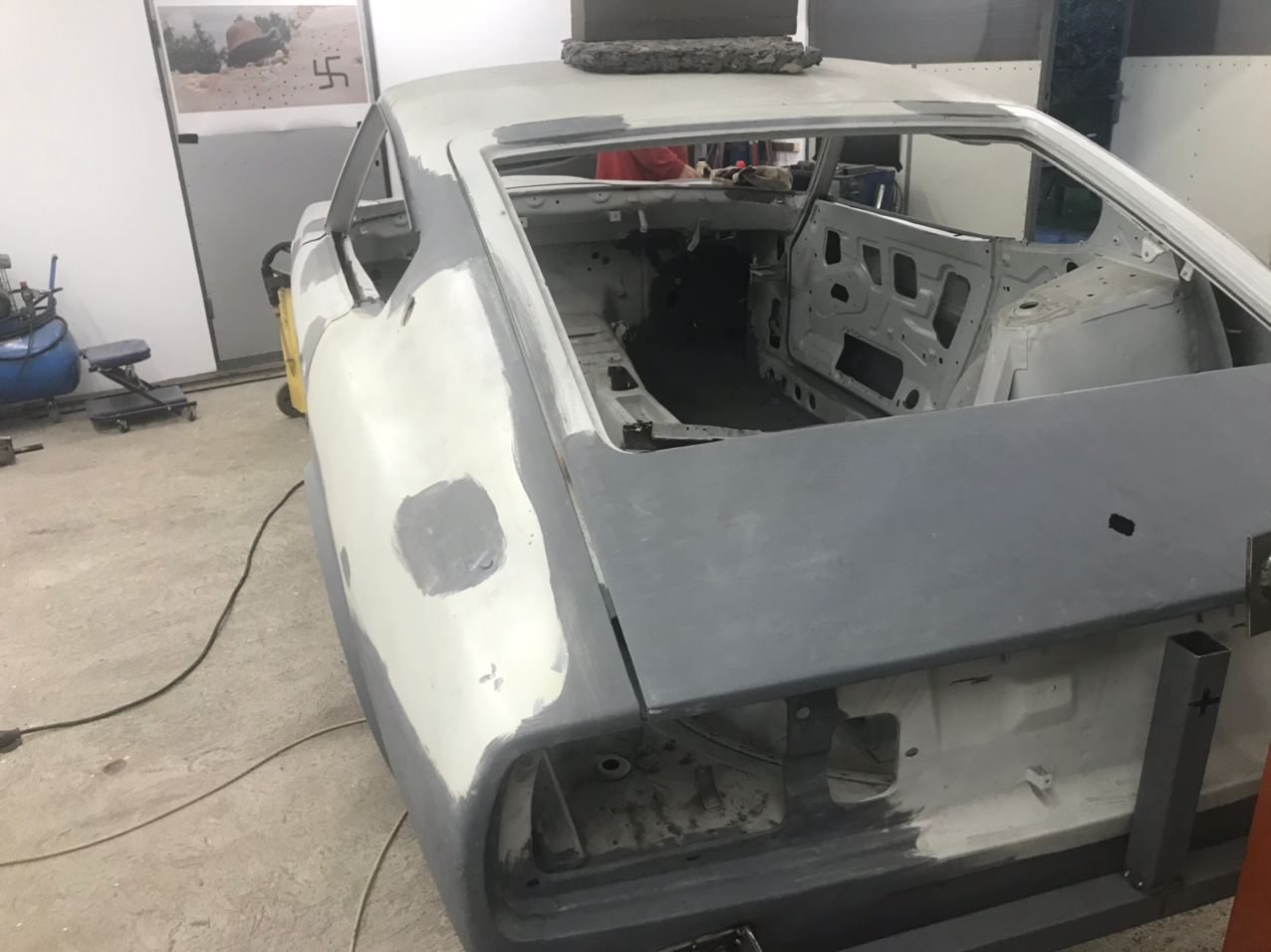 Datsun 280Z door and rear quarter in guide coat during bodywork refinement before painting