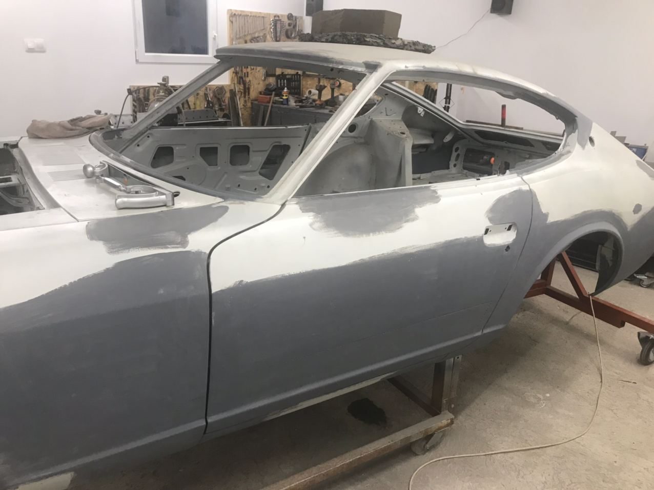 Datsun 280Z shell in guide coat on the rolling frame, bodywork complete and ready to go to the painter