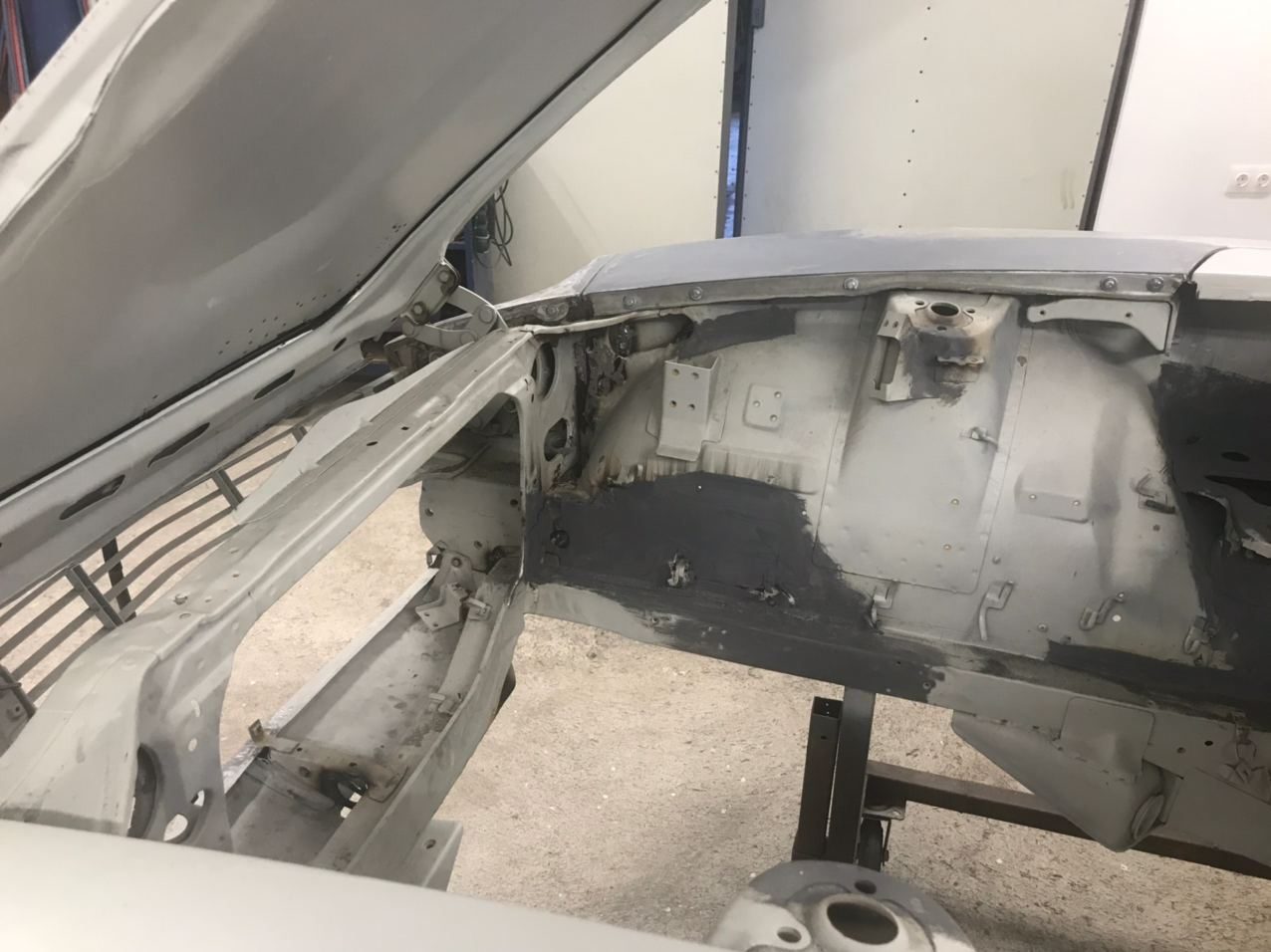 Datsun 280Z shell in primer with body filler and guide coat, panels being blocked straight before paint