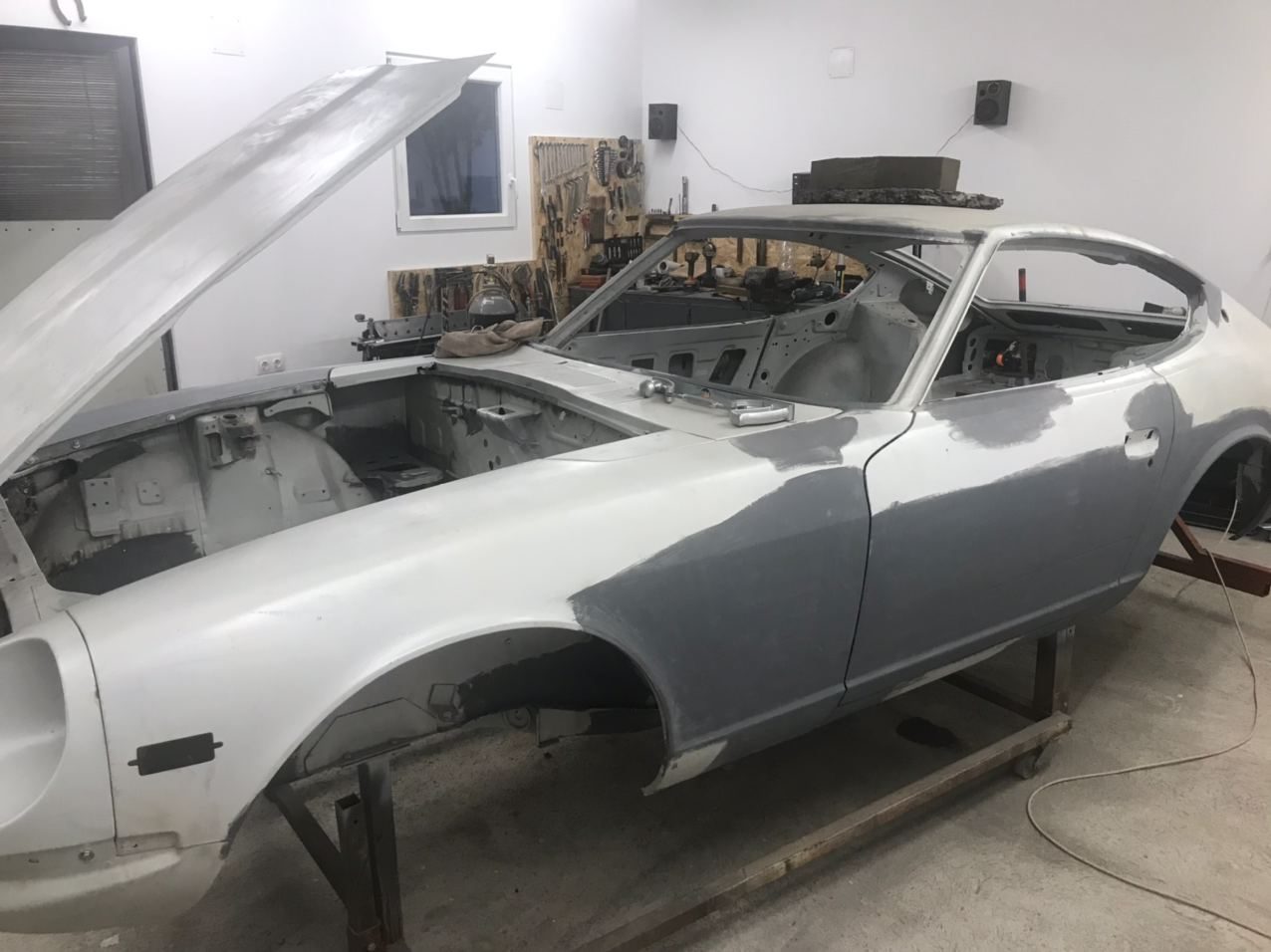 Datsun 280Z engine bay in primer, prepared to the same standard as the exterior before paint