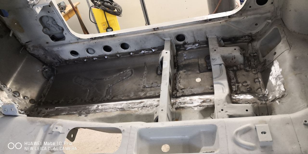 Datsun 280Z floor pans replaced with new steel, fresh welded panels across the cabin floor during restoration