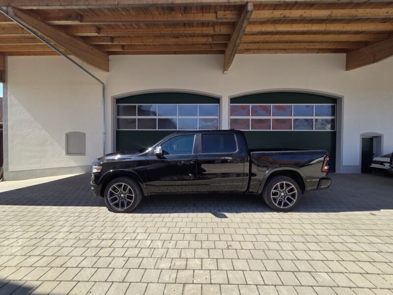 dodge Ram 1500 Gen 5 2022 Limited Black pickup truck main side profile image with 22 inch wheels